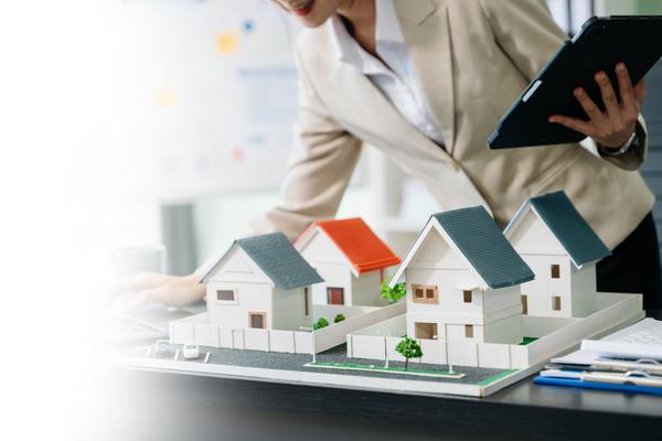 Property manager reviewing residential property models with tablet